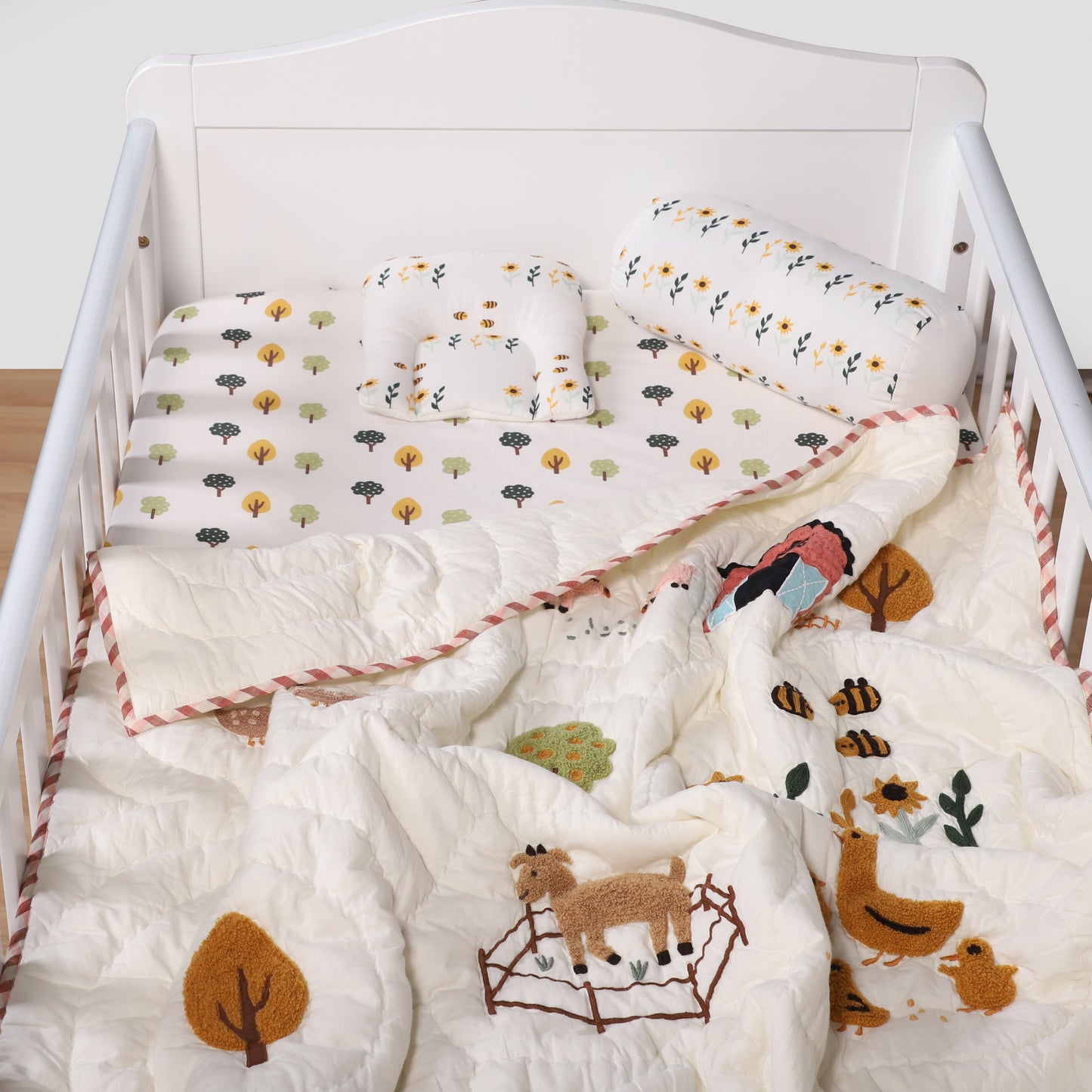 Crib with white bedding featuring animal prints on a light background