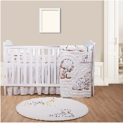 A gray elephant baby quilt with big ears and a playful trunk design, displayed in a nursery setting with pastel accents and a round white rug.
