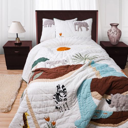 A children's quilt set with a jungle theme, including quilt and pillowcases with animal appliqués such as an elephant and giraffe, displayed on a bed.