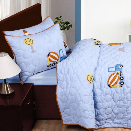 A quilt with construction vehicles design, displayed on a bed with pillow cases.