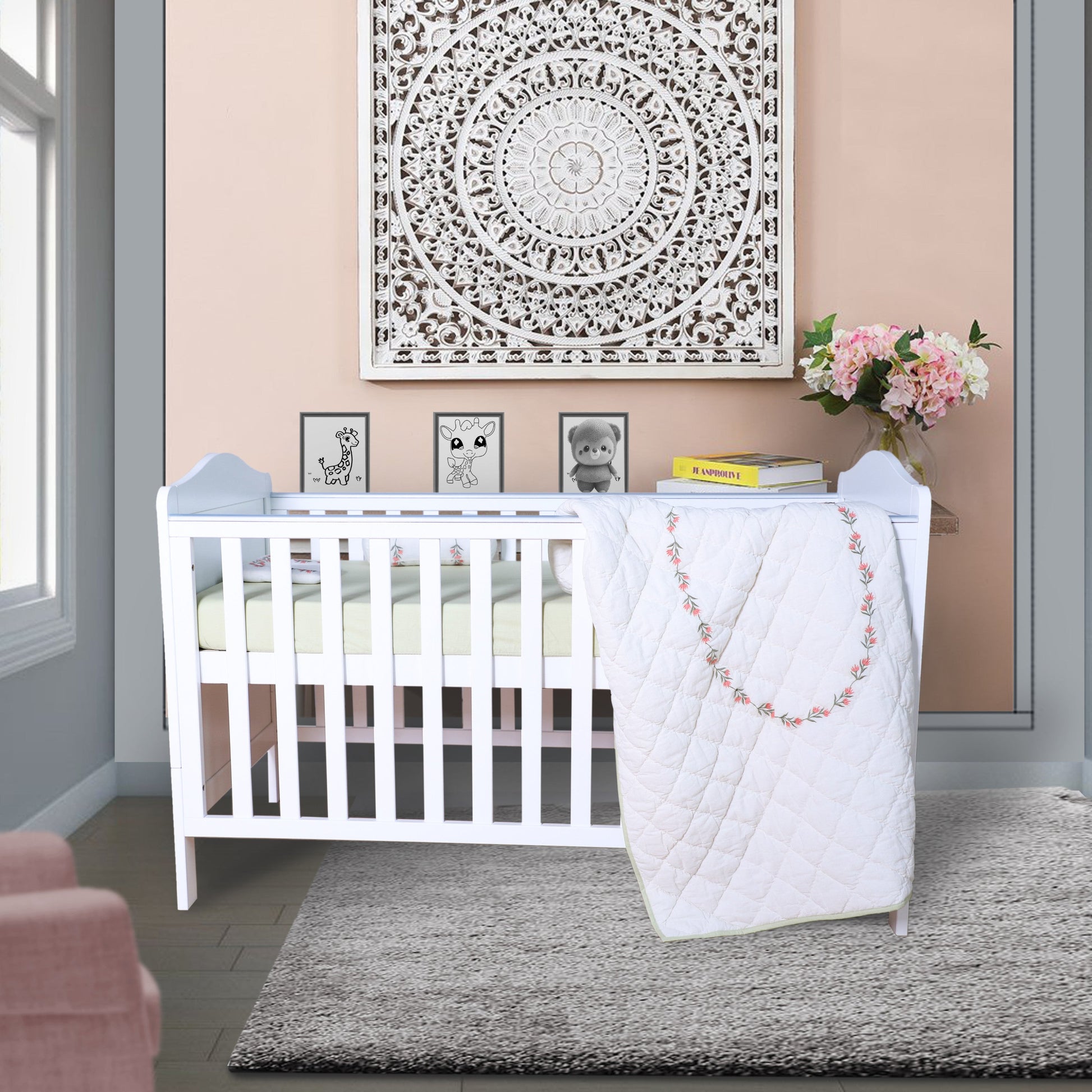 Nursery room with a white crib, pink chair, and decorative elements.