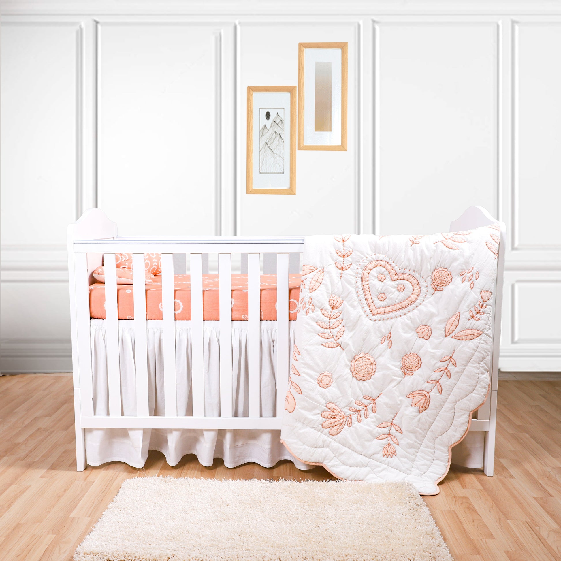 Nursery room with a white crib and pink bedding