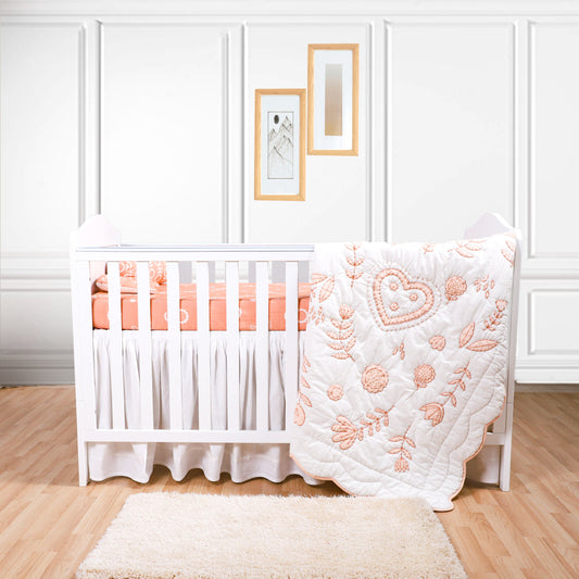 Nursery room with a white crib and pink bedding