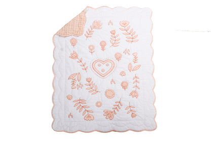 Embroidered baby blanket with floral patterns and a heart on a white background