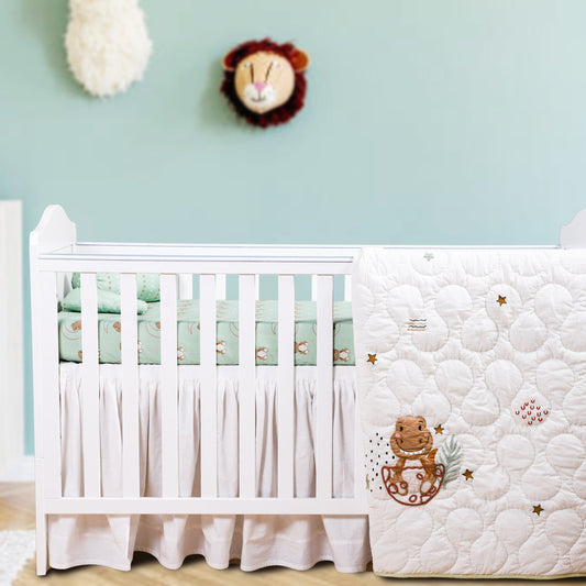 White crib with teddy bear design in a nursery room