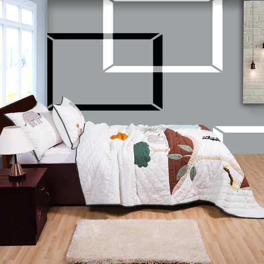 Bedroom with a floral-patterned comforter on a bed, side table, and rug.