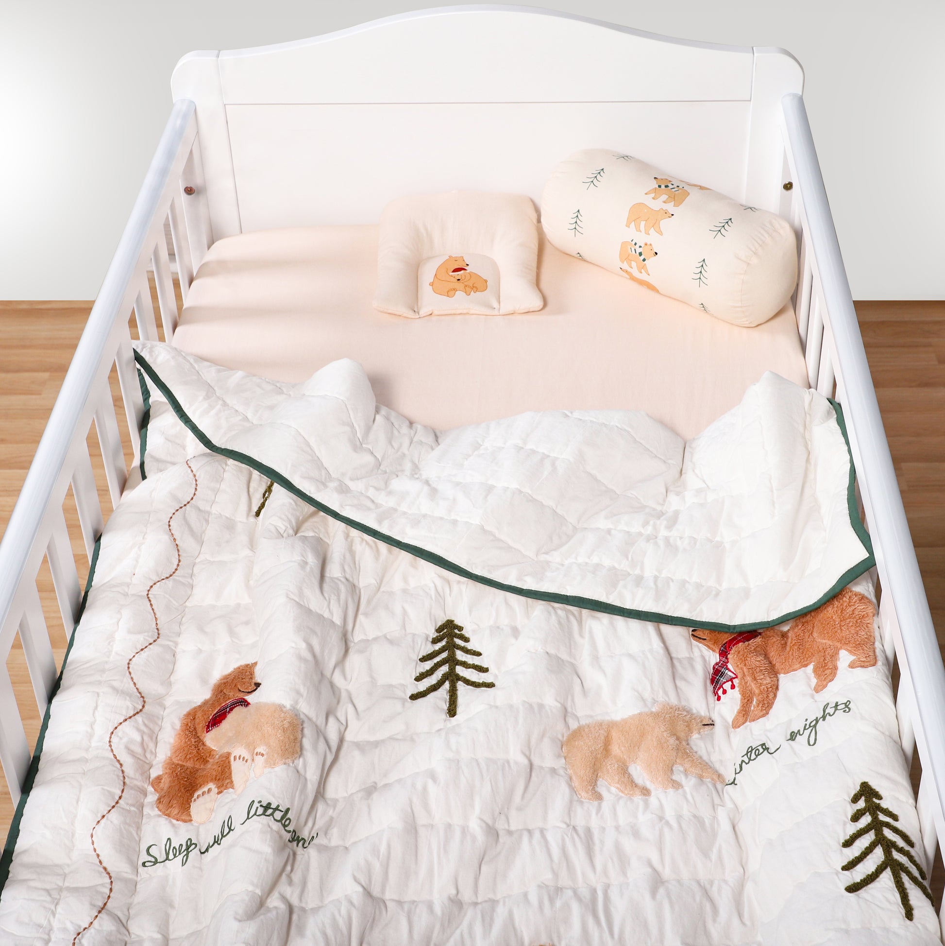 Baby crib with wooden floor and white wall background