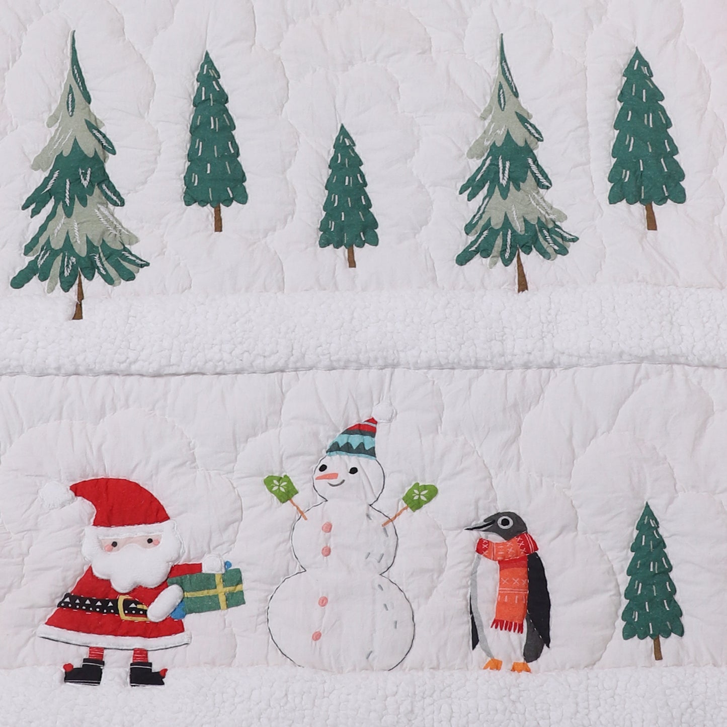 Quilt with Christmas-themed design featuring Santa, snowman, penguin, and trees.