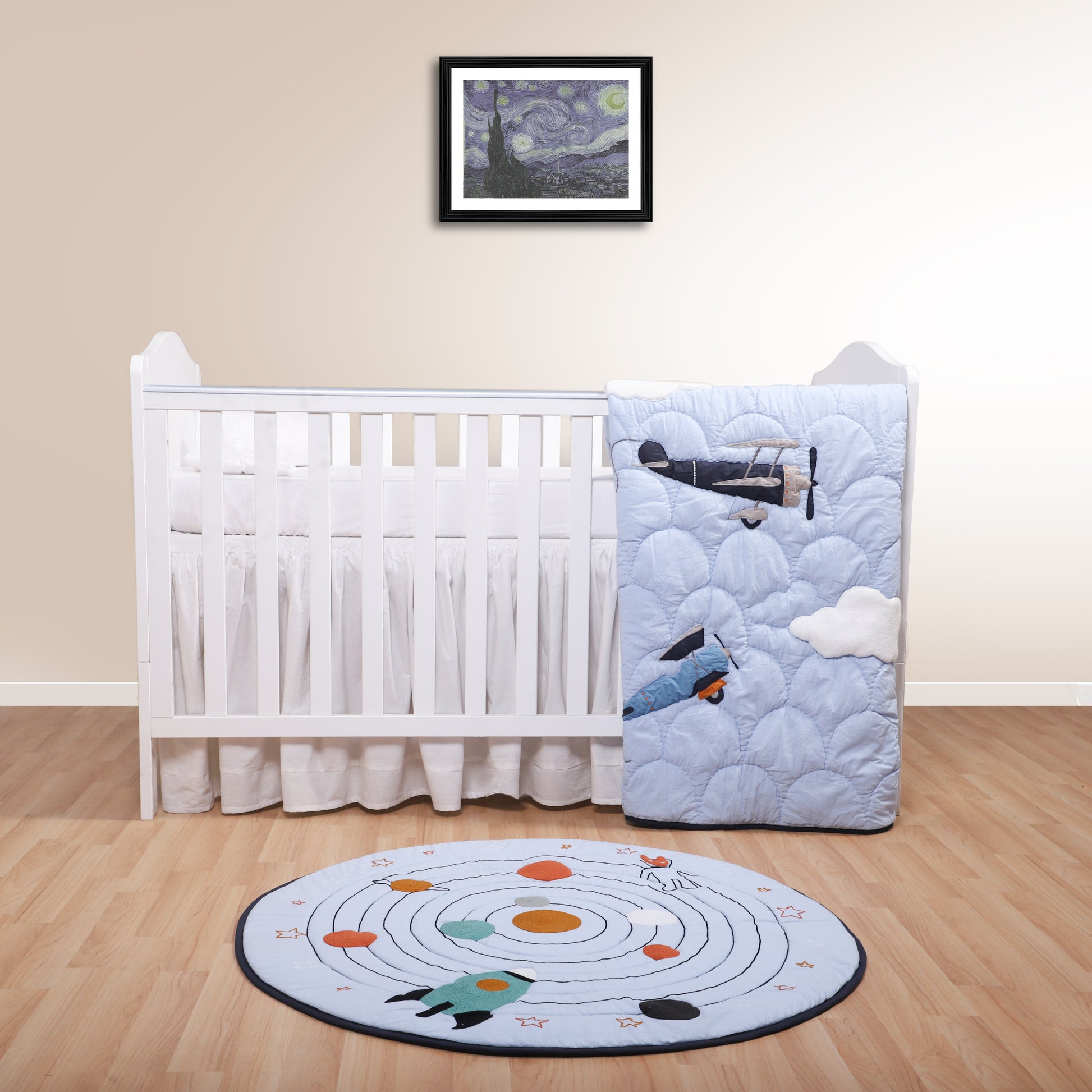 Nursery room with crib, quilt, and rug on a wooden floor.