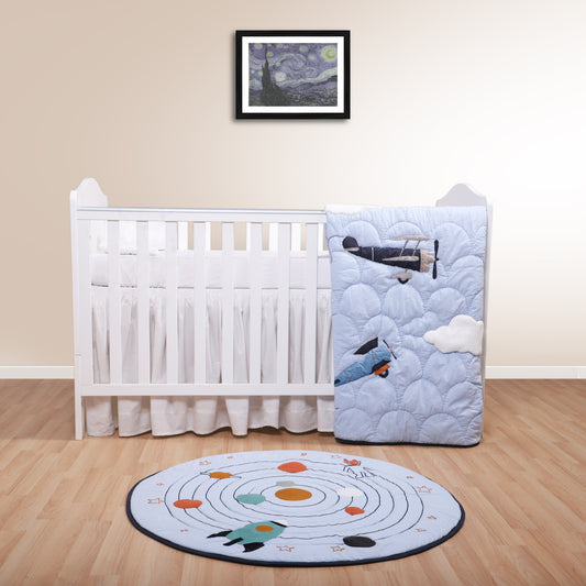 Nursery room with crib, quilt, and rug on a wooden floor.