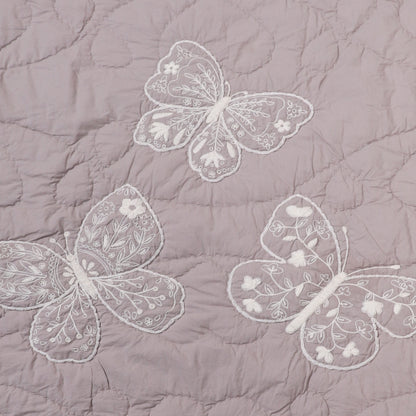 Embroidered butterflies on a quilted fabric background