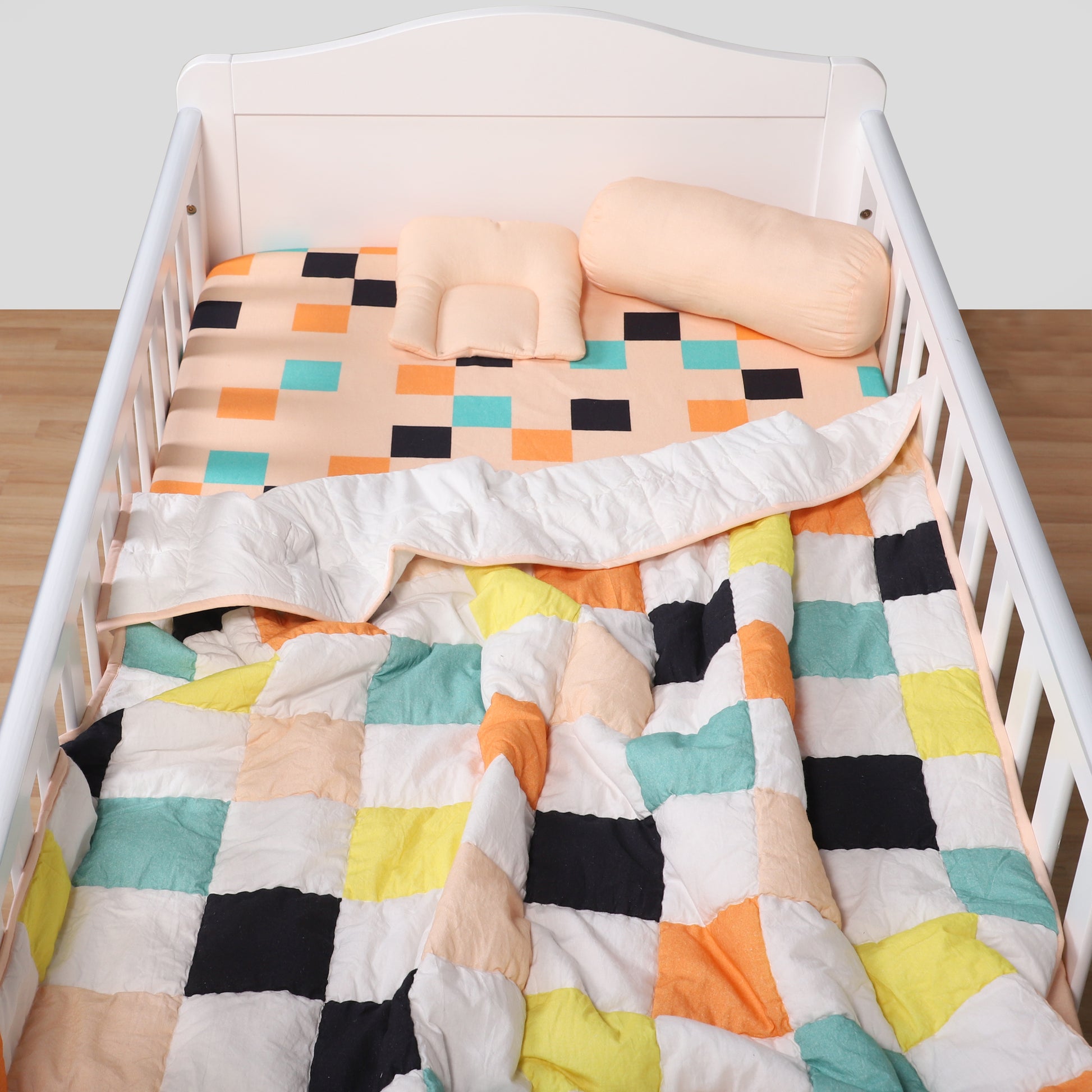 Colorful quilt with geometric pattern on a crib