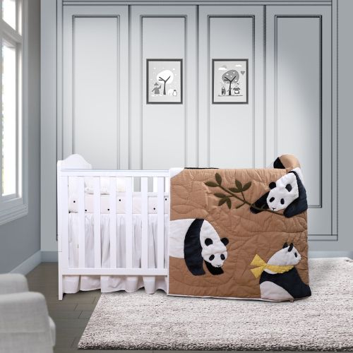 A baby quilt with a panda print displayed in a nursery room.