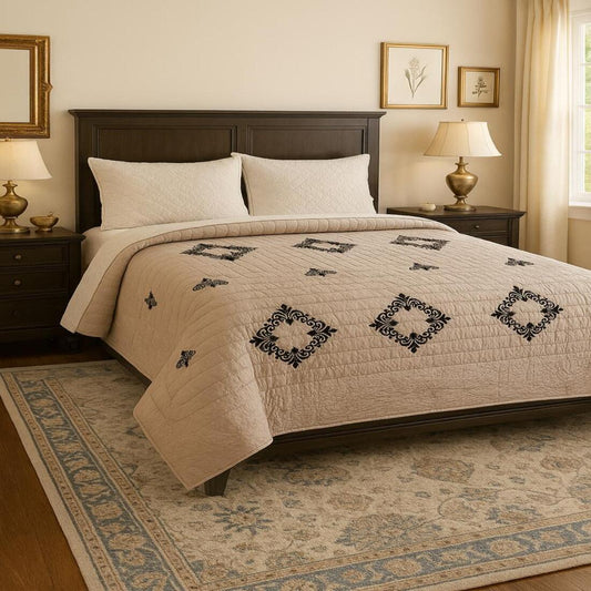 Neatly made bed with decorative quilt in a bedroom setting.
