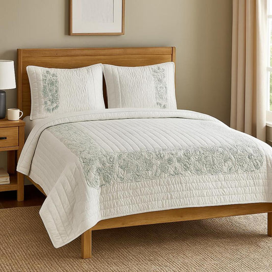Bedroom with wooden bed, white bedding with green embroidery, and nightstand.