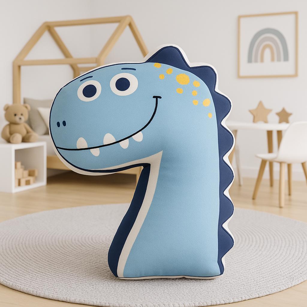 Blue dinosaur-shaped pillow on a round rug in a room with a teddy bear and rainbow decorations.