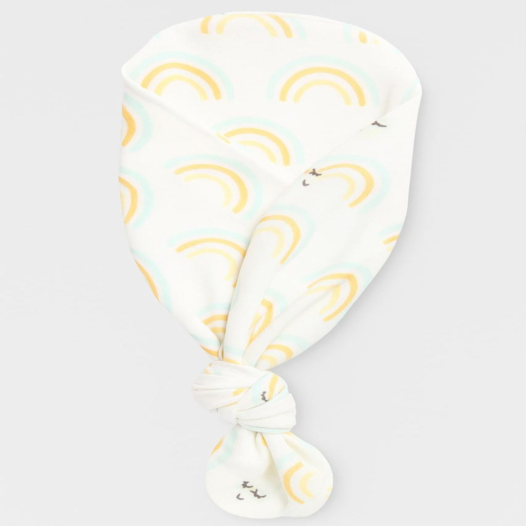 White headscarf with yellow rainbows and cloud patterns on a light gray background