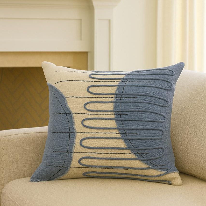Decorative pillow with geometric pattern on a beige sofa