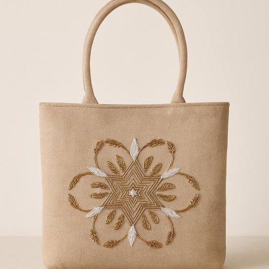 Beige tote bag with intricate gold embroidery on a beige background