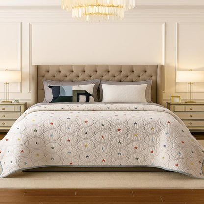 Bedroom with a bed featuring a decorative quilt and pillows.