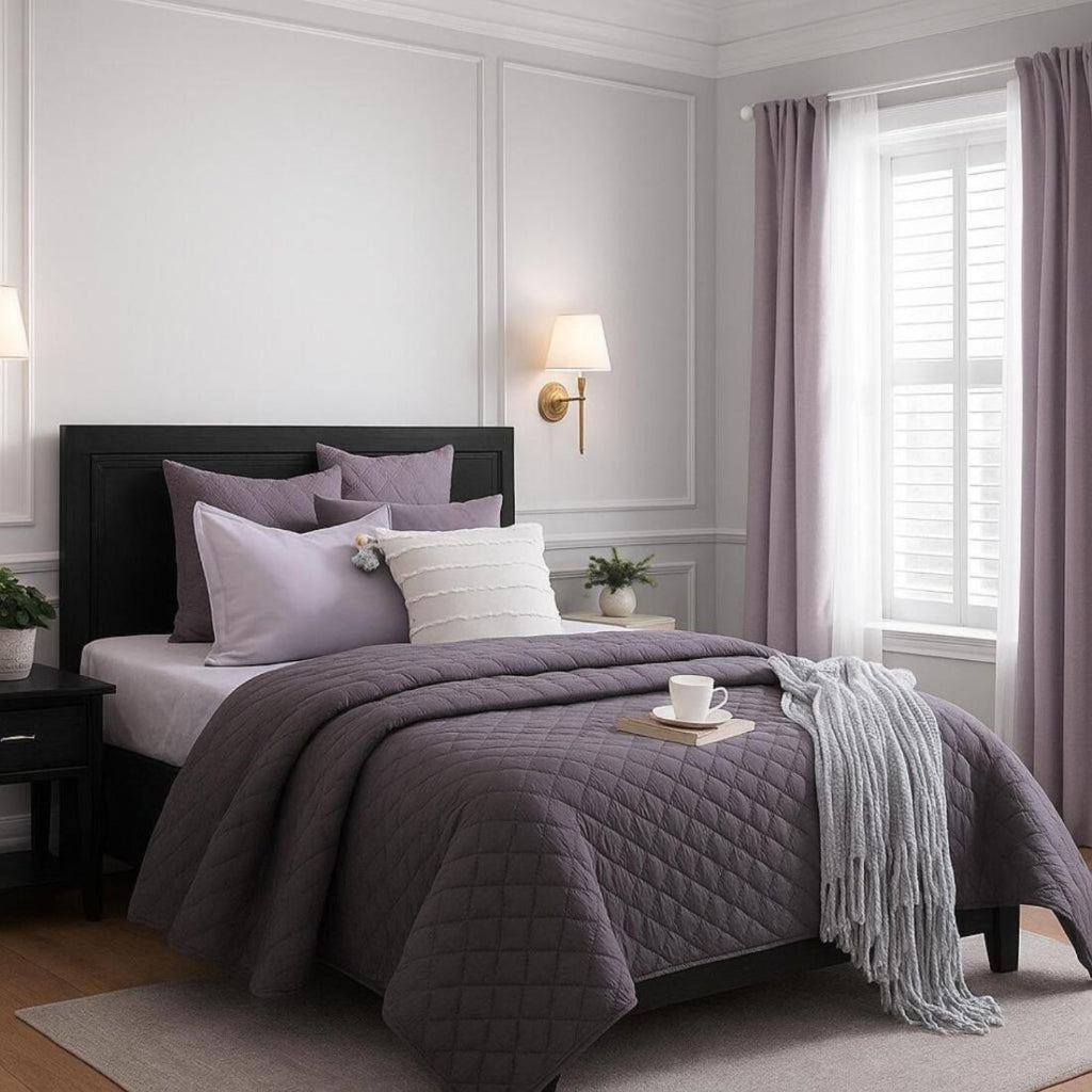 Bedroom with a bed covered in purple bedding and pillows, next to a window with pink curtains.