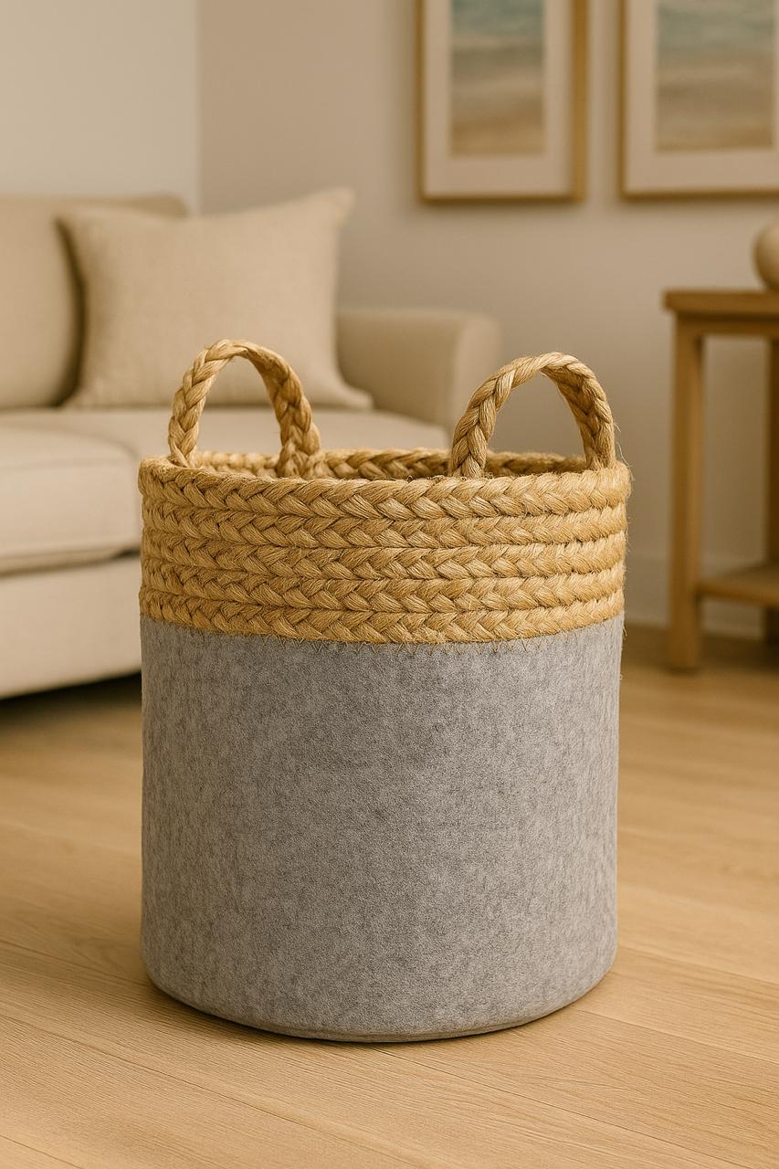 Woven basket with gray base and beige top in a living room setting