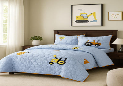 Children's bedroom with blue quilt set featuring construction vehicle designs.