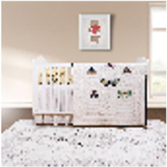 A colorful baby quilt with a butterfly pattern displayed on a bed in a nursery room.